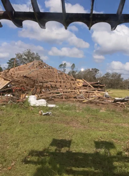 Excavator clearing a residential property for demolition in Ocala, Florida