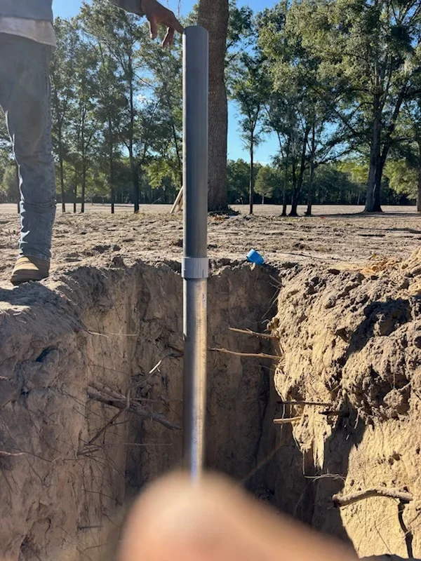 Metal pipe removal from deep trench excavation with reinforced soil walls