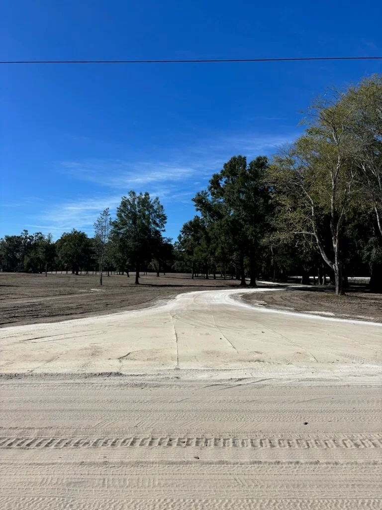 Cleared concrete pad removal with graded soil and compacted earth on rural property