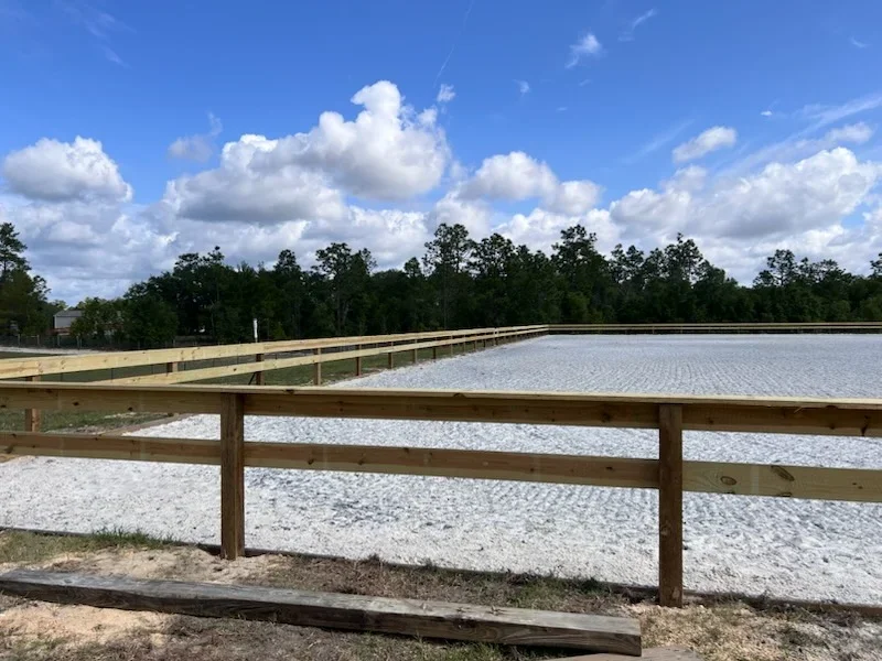 Cleared and graded land with wooden rail fencing, ready for development